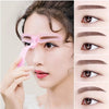 A woman is using a pink reusable eyebrow shaping stencil kit to define her eyebrows.