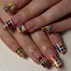 A hand displays a set of 24 press-on coffin nails featuring multicolored plaid designs in pink, blue, and white.