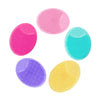 A set of five silicone facial cleansing brushes in various shades of pink, blue, and yellow.
