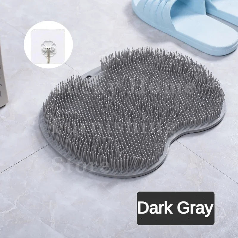 A dark gray silicone foot scrubber with numerous bristles is shown on a light surface.