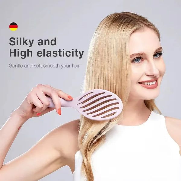 A woman is using a pink hollow-out detangling hair brush on her blonde hair.