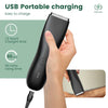 A hand is using a black USB portable charging electric body shaver trimmer on skin.