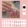 A hand displays leopard print French tip press-on nails with 3D gold pearl designs.