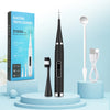 A black electric tooth cleaner device with a silver brush and cleaning tools displayed on a light blue background.