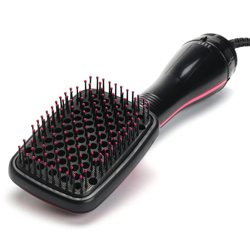 A black professional hot air hair dryer brush with numerous fine bristles and a handle is shown against a white background.
