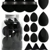 A set of fifteen black makeup sponges and applicators stored in a glass jar.