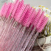 A bundle of pink and clear disposable eyelash and eyebrow makeup brushes with glitter accents.