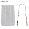 A stainless steel and copper tongue scraper is shown next to a light gray cloth bag.