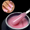 Un constructeur de gel moyen auto-nivelant rose pour extensions de ongles, présenté dans un pot avec une spatule cosmétique e