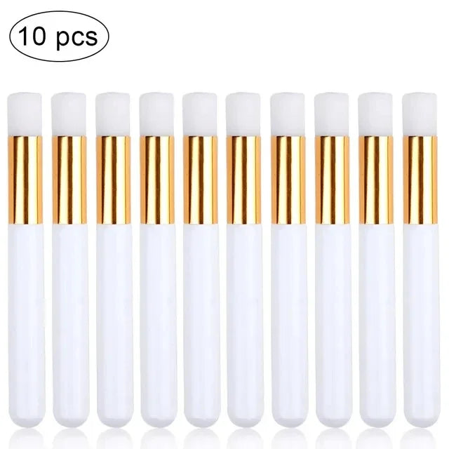 A set of ten white and gold eyelash extension cleaning brushes with nylon bristles.