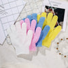 A collection of colorful exfoliating mitts in white, pink, blue, and yellow laid out on a light surface.