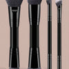 A set of six black makeup brushes with silver ferrule and white hair, shown standing upright.