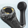 A black 360° rotating silicone facial cleansing brush is shown submerged in water.