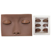 A realistic silicone mannequin head with painted eyes and lashes used for eyelash extension practice.