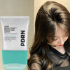 A woman is shown using a white tube of PDRN Reedle Shot Brush Hair Serum for daily scalp care.