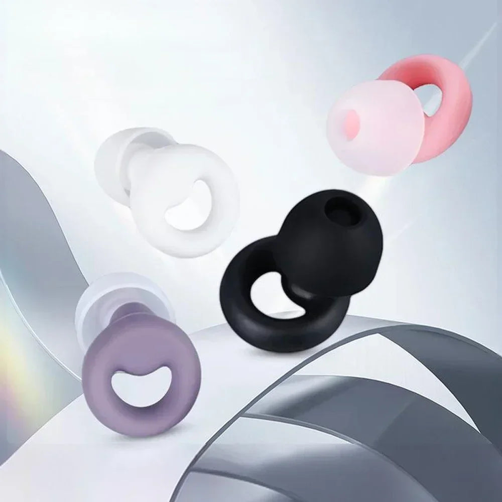 A collection of silicone earplugs in various pastel and dark colors are shown against a light gray background.