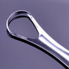 A close-up view of a stainless steel tongue scraper tool against a gray background.