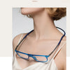 A pair of blue-framed reading glasses with mirror lenses being worn by a woman.