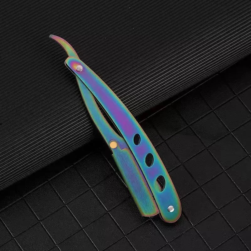 A manual straight edge shaver kit with iridescent purple and blue blades resting on a dark surface.