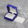 A blue box containing and displaying a stack of white stainless steel single-sided shaving razor blades.