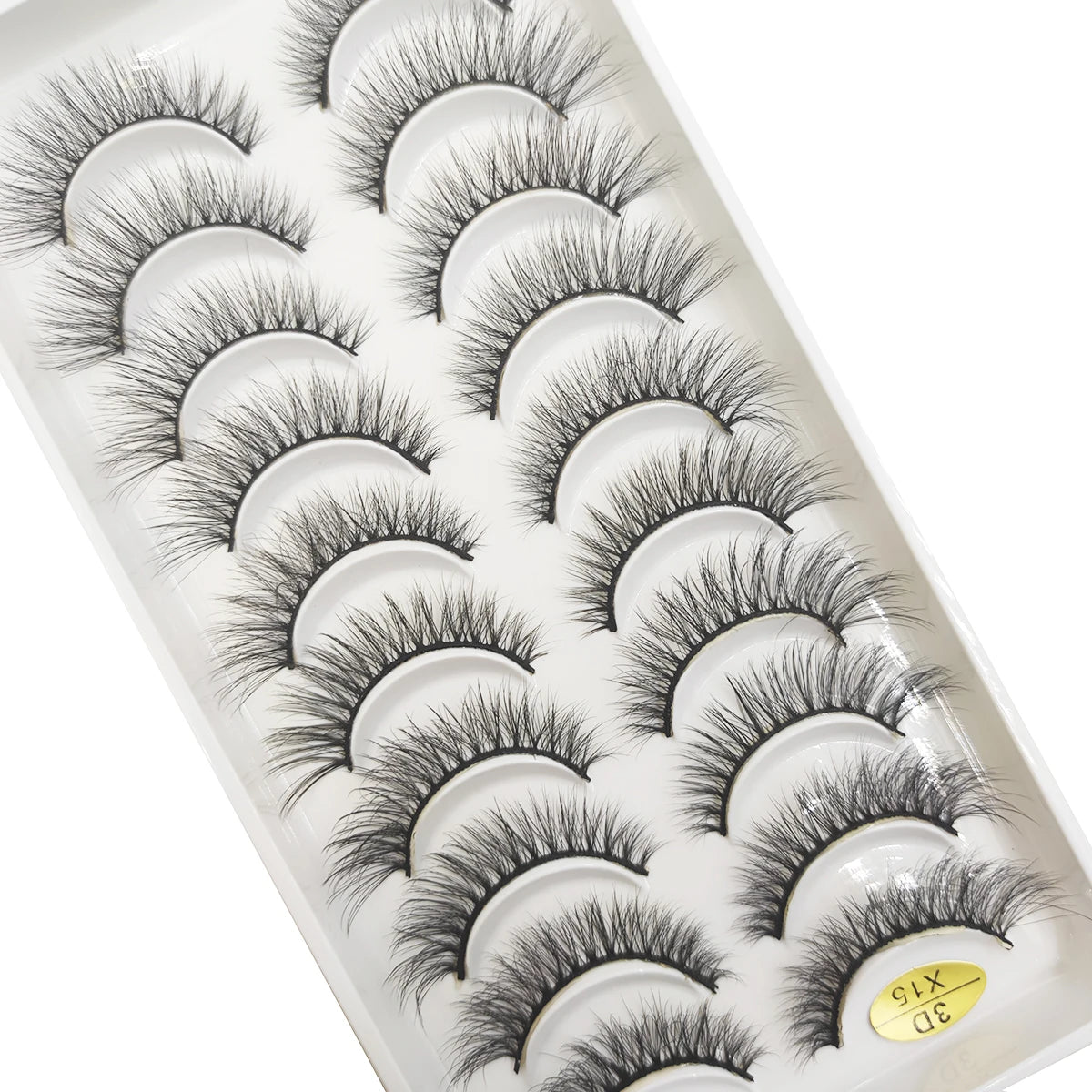 A tray of natural 3D mink false eyelashes displayed in a white plastic container.
