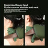 A close-up of a green bionic hand massager being applied to the neck and shoulder area.