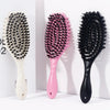 Three styling combs with varying bristles and pink, black, and white handles displayed against a white background.