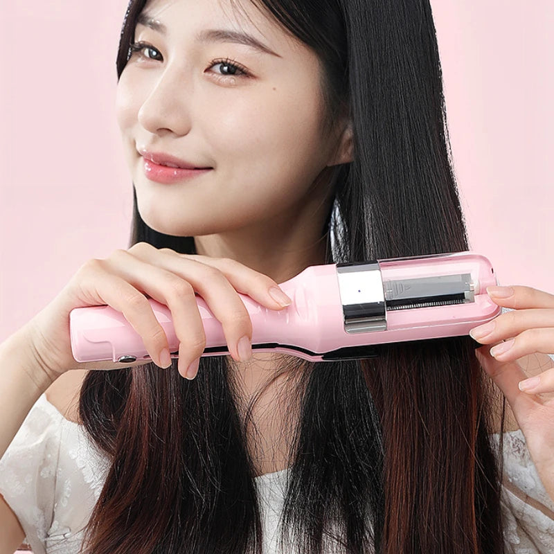 A woman holds a pink automatic hair ends trimmer against her long dark hair.