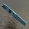 A blue anti-static professional hair cutting comb lying on a wooden surface.