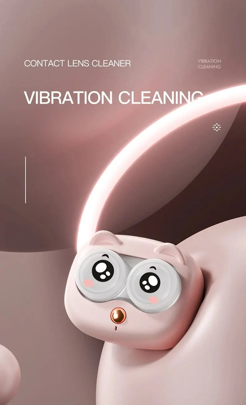 A pink, cat-like creature holds a contact lens cleaning device with a vibration feature.