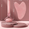 Pink and white resin roller beauty device with a heart-shaped scratch plate shown on a wooden surface.