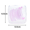 A clear plastic kit containing multiple pink artificial eyelashes for curling and lifting.