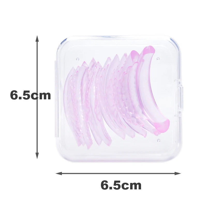 A clear plastic kit containing multiple pink artificial eyelashes for curling and lifting.