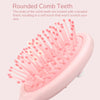 A pink cartoon mini air cushion massage comb with rounded teeth is shown in a close-up view.