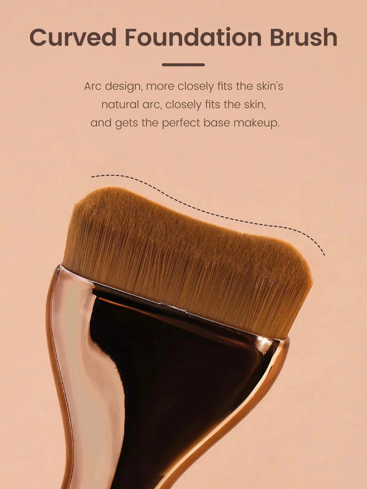 A close-up of a curved foundation brush with golden bristles and a metallic handle.