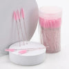 A set of pink and silver disposable eyelash and eyebrow makeup brushes displayed next to a pink cosmetic container.