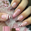 A set of press-on nails featuring a pink flower and star design on a sheer pink background, displayed on a hand against pink 
