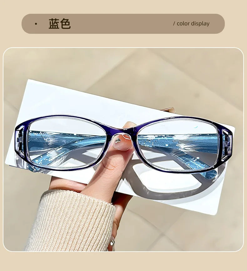 A pair of blue-tinted reading glasses resting on a white surface, demonstrating the color display.