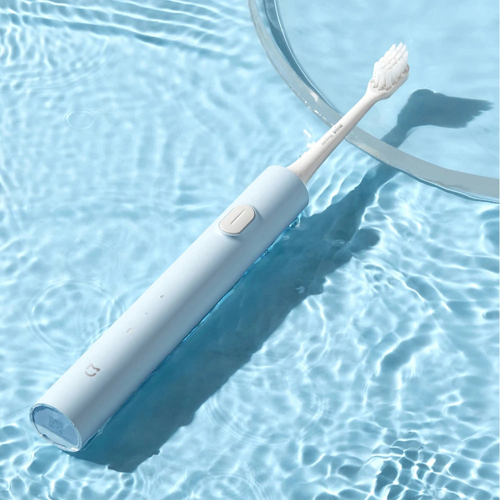 A white sonic electric toothbrush with a brush head is shown floating in clear water.