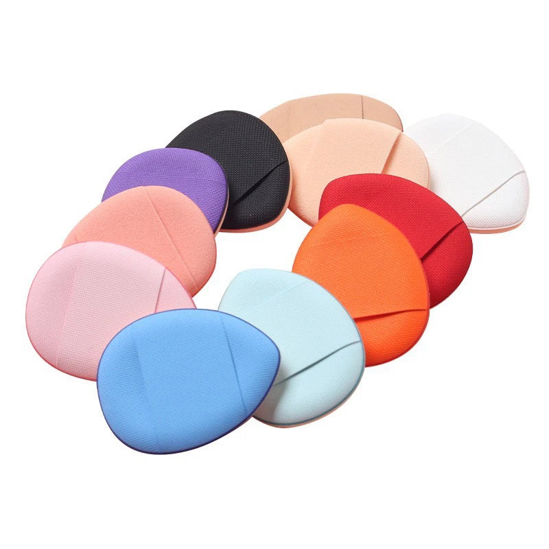 A collection of mini finger puff foundation applicator tools in various pastel and earthy tones.