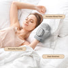 A woman is using a gray electric hand massager on her arm while relaxing in bed.