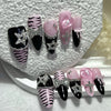 A set of glitter diamond press on nails featuring black, pink, and zebra print designs.