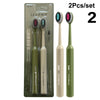 Un set de deux brosses à dents professionnelles à double poil dans des emballages vert et beige.