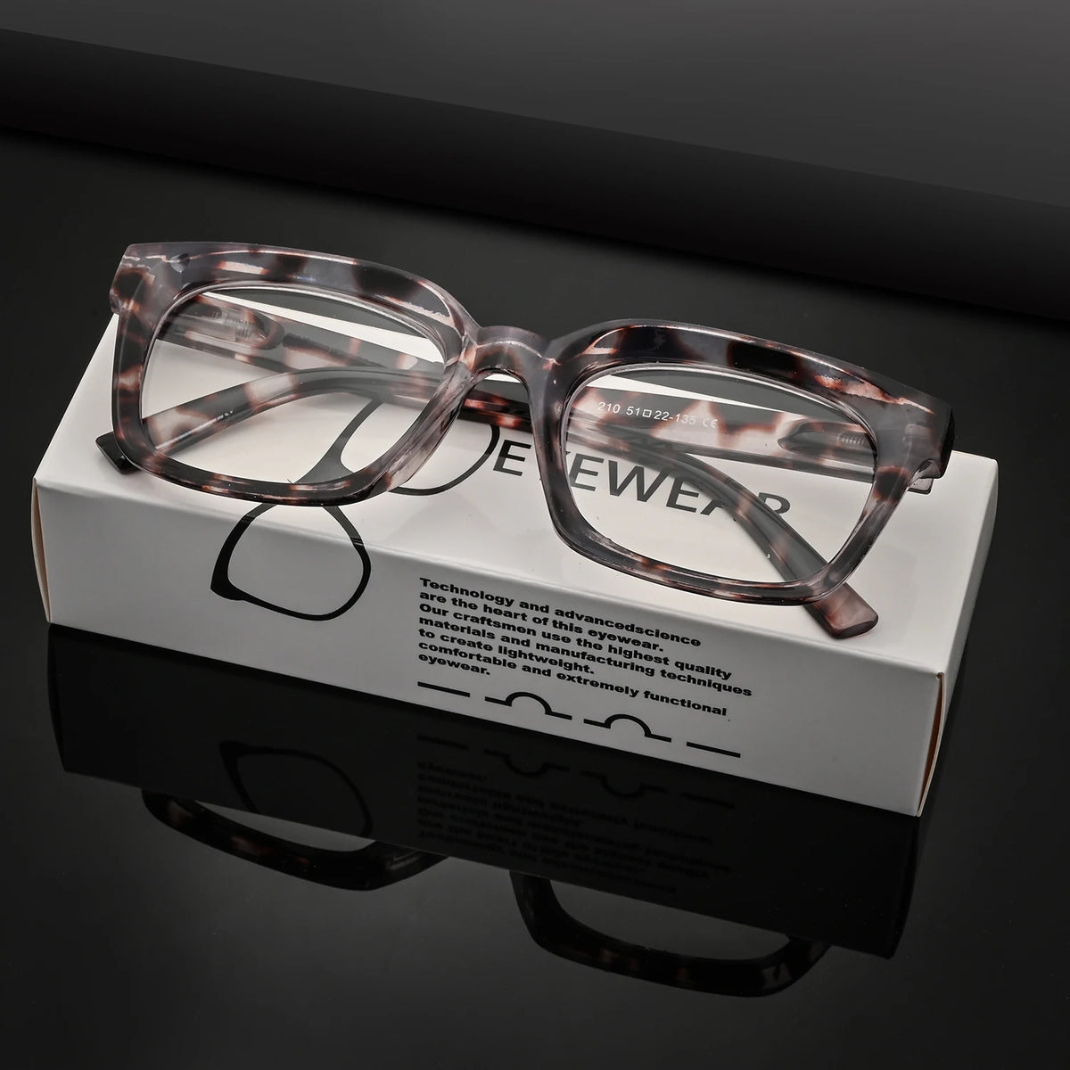 A pair of tortoiseshell and leopard print blue light blocking reading glasses displayed in their box.