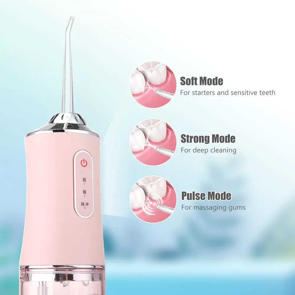 A pink portable oral irrigator device with three modes: Soft, Strong, and Pulse.