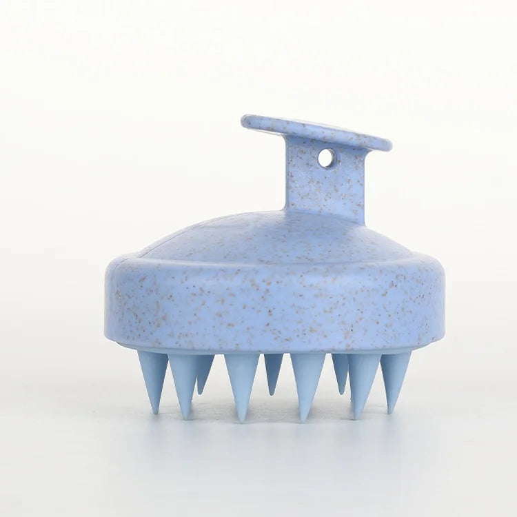 A light blue silicone body and scalp massage brush with a handle and multiple pointed bristles.