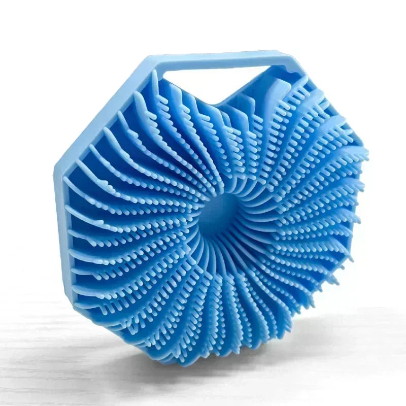 A light blue silicone exfoliating shower scrub brush with a textured, fan-like head.