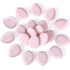 A collection of pink makeup sponge puffs arranged in a circular pattern.