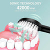 A black electric toothbrush is shown cleaning the teeth of a person, demonstrating sonic technology for deep cleaning.