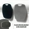 A black silicone body scrubber and a gray textured silicone scrubber are shown next to a smooth wall surface.